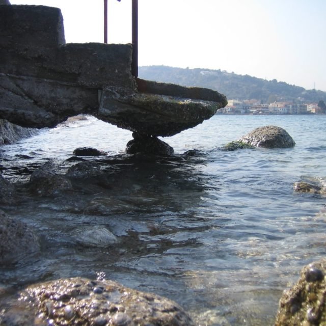 Aigeira - Wave Battered Stairs Supported by Boulder